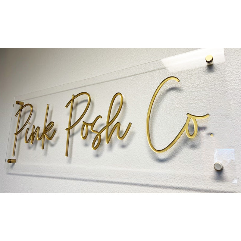 clear and gold acrylic wall business sign with standoffs